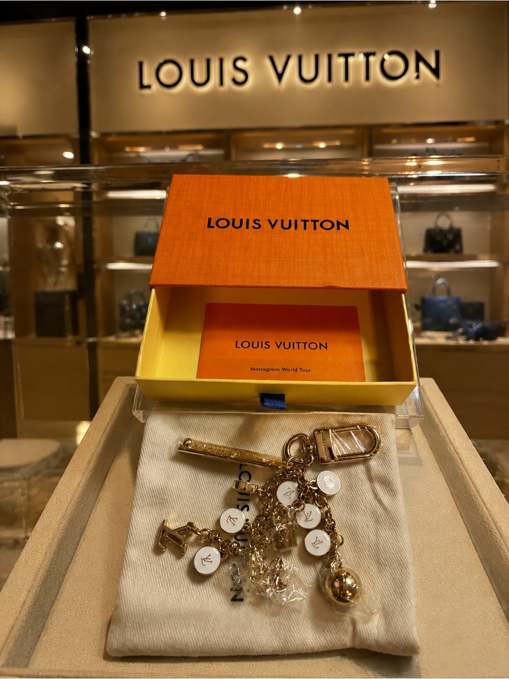 Elegant Louis Vuitton Gold-Tone & White Monogram Charm Keychain stamped